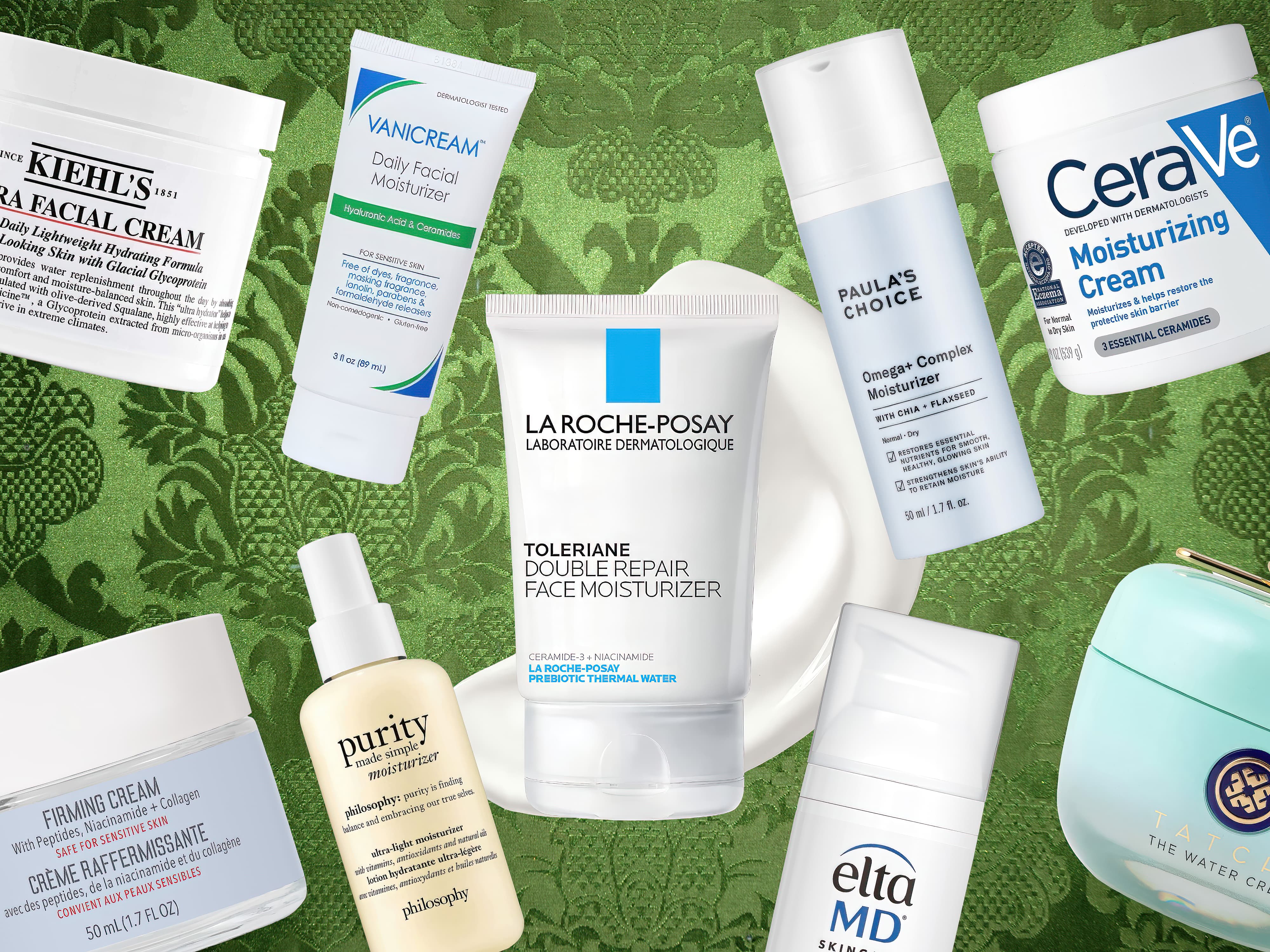 An assortment of the best moisturizers from various brands arranged on a decorative green background