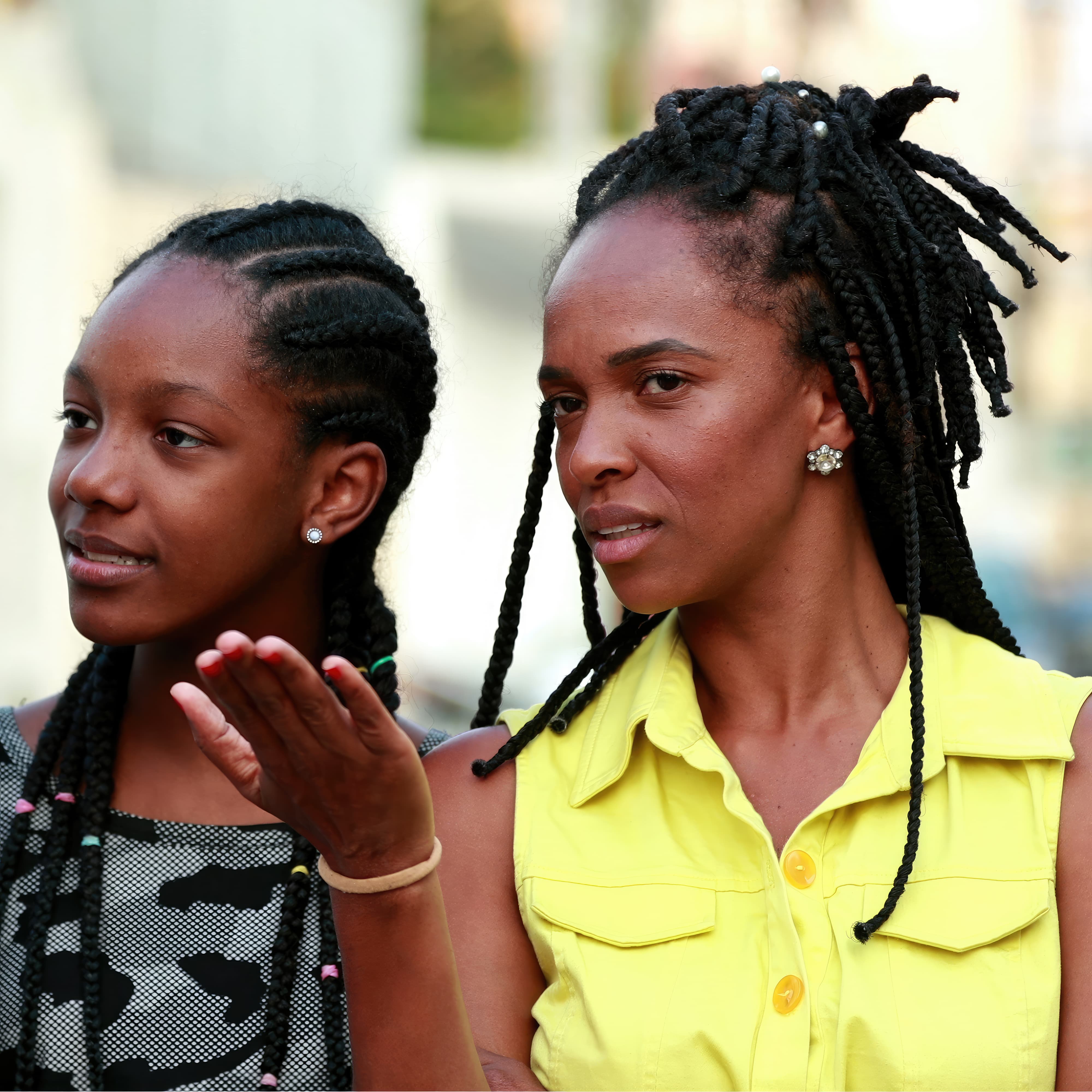 Mother and teen daughter looking at other people and judging them