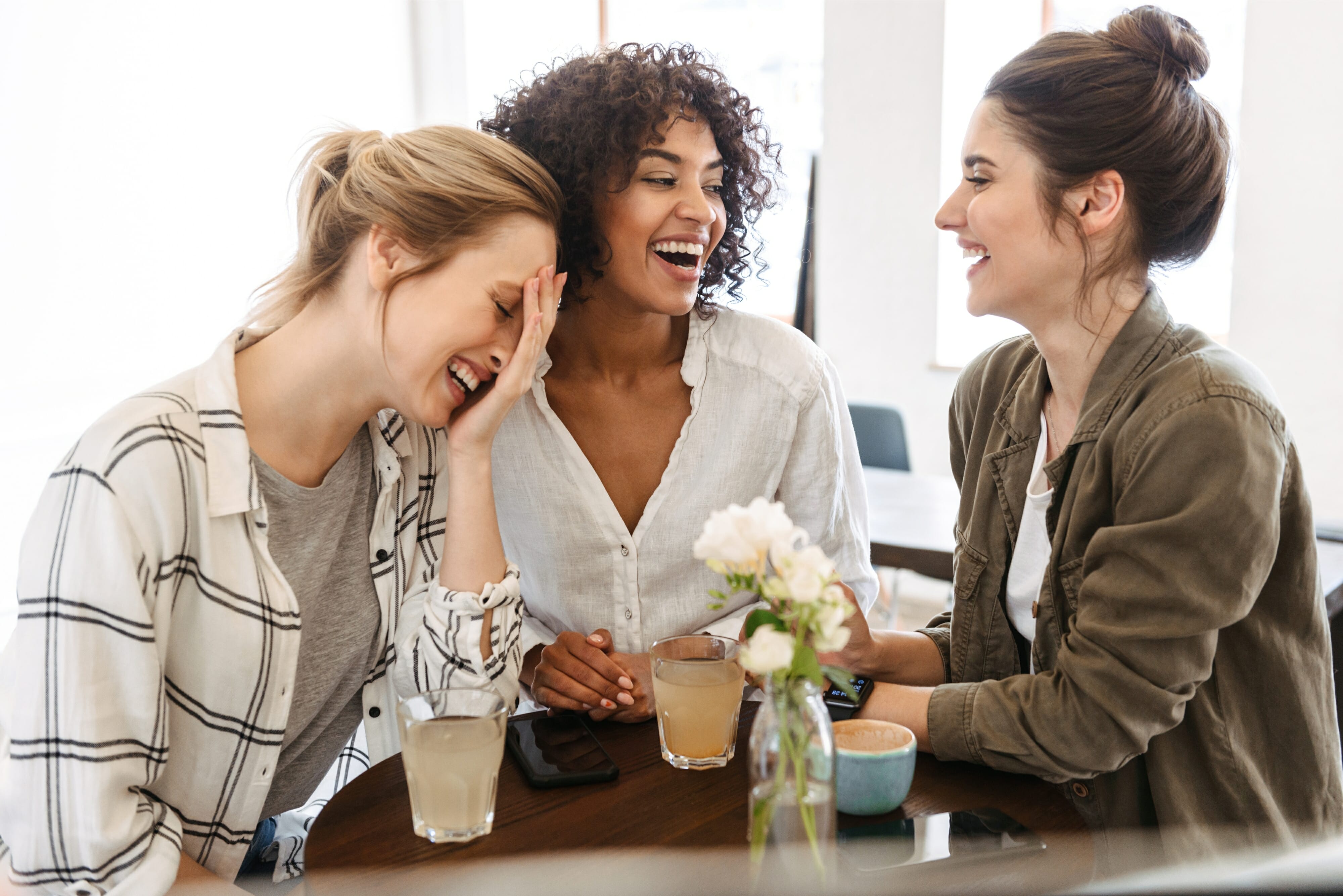 Women laughing at a cafe